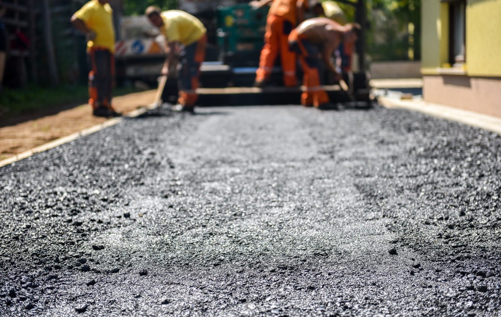 Team of Workers making and constructing asphalt road constructio VG 40 bitumen is suitable for road construction at hot temperatures